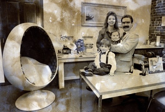 Mark and Kim Moore with their two young sons inside the family hearing-aid clinic, 1989. A young Matthew Moore is seated at the front of the photo.